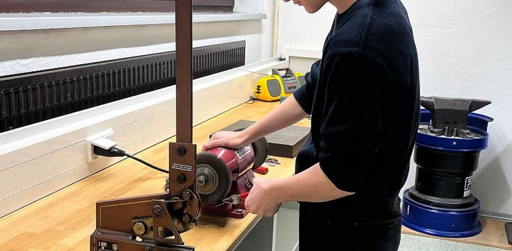 Metall_4_25 Bild zeigt einen Schüler bei einer Maschine in der Metallwerkstätte